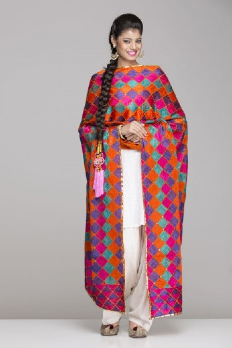 White salwar suit with orange & dark pink phulkari 